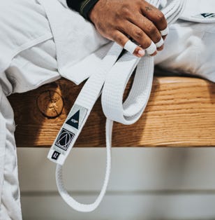 Close up of student holding a white belt