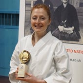 Cyrielle holding a trophy at a championship 