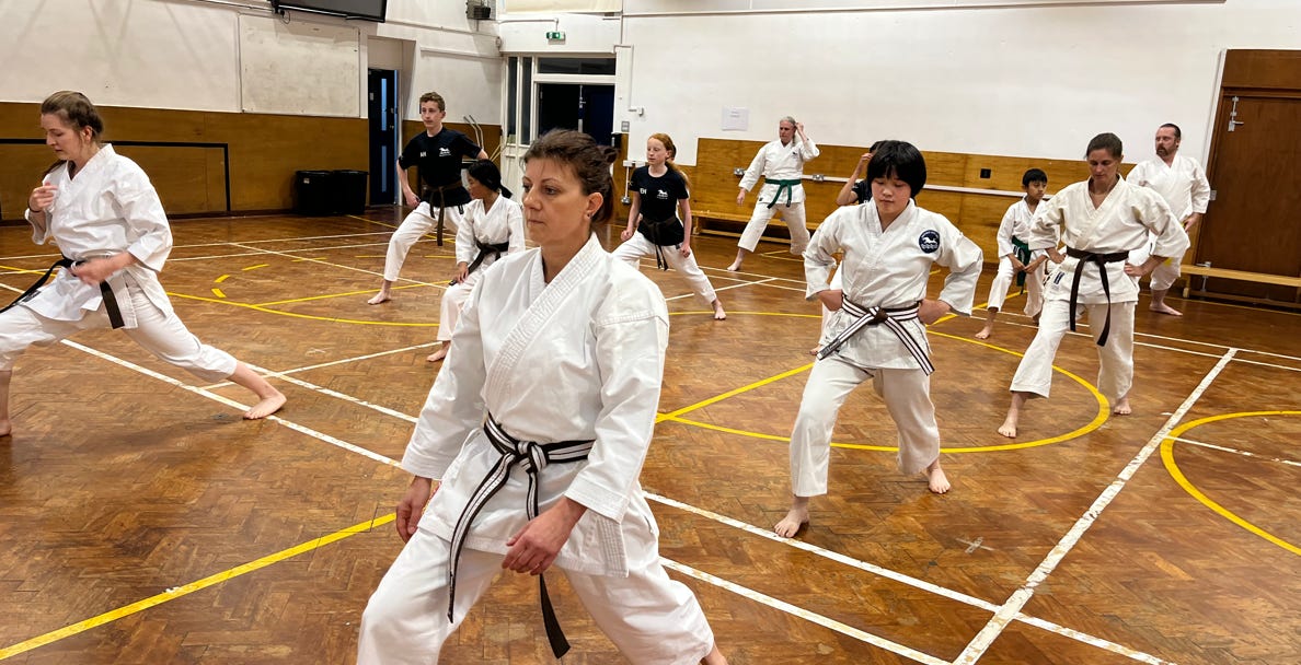 Warm up at Cherwell School. Enthusiastic students of all ages, ignite energy and focus at the Karate lesson in Cherwell School, emergise mind and body, explore free trial class, Cherwell school, Karate Karate for kids, Karate for adults, free trial classes, martial arts, training, fitness, self-defence